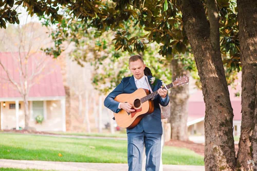 groom playing a song for his bride on their wedding day