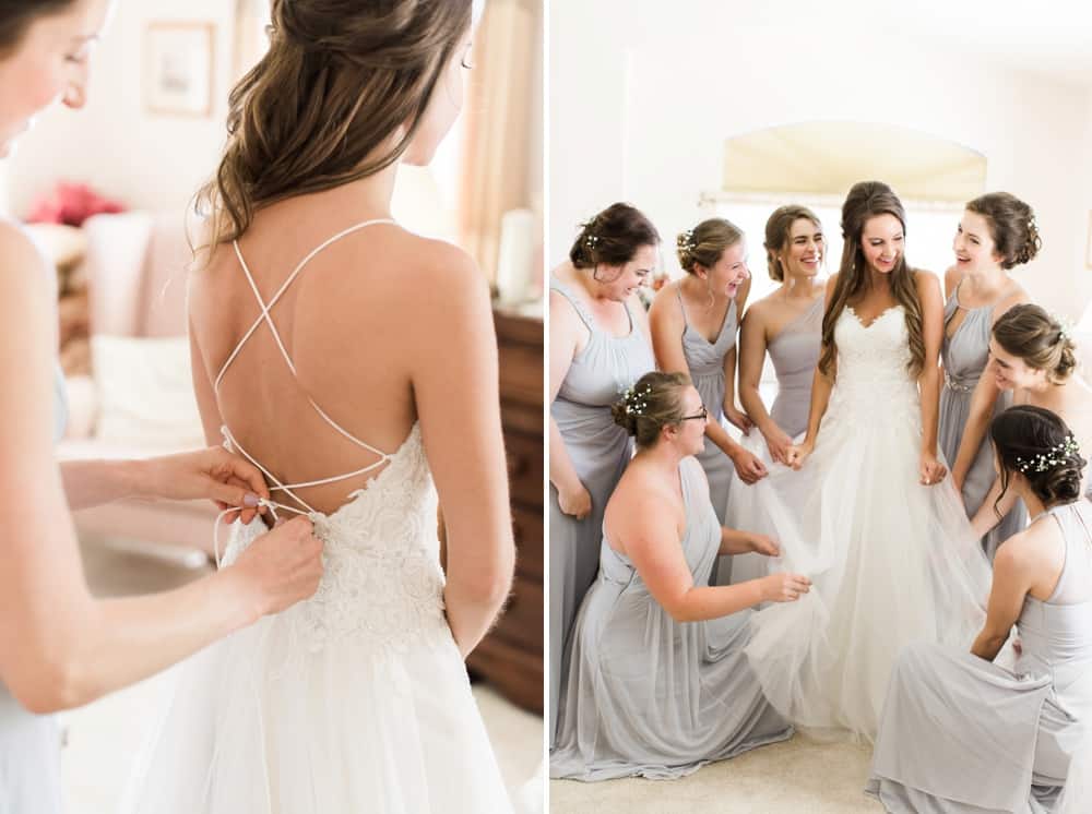 bridesmaids helping bride get into her dress