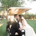 newlyweds kissing in a golf cart