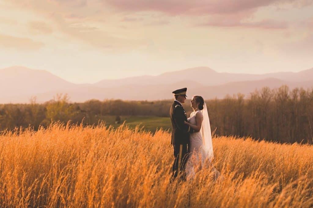bride and groom dancing in the field for sunset photos