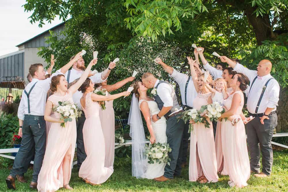 bridal party cheering for newlyweds