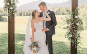 A perfect couple at a vineyard wedding wearing a wedding dress from Ashley Grace Bridal