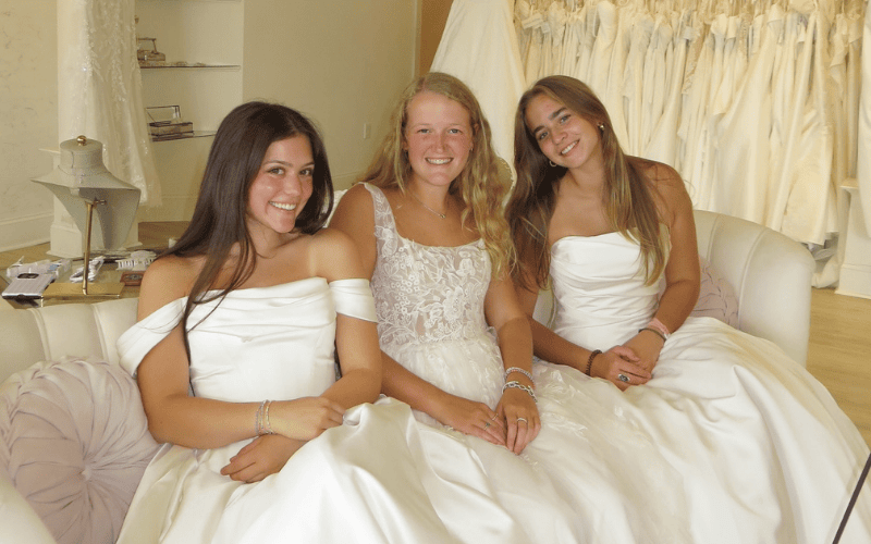three brides sitting on the sofa at ashley grace bridal