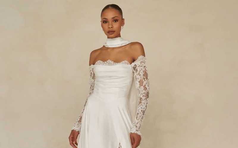 bride wearing a satin gown with bridal gloves and a bridal scarf