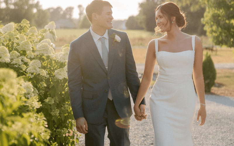 bride beside the groom wearing a sheath wedding dress
