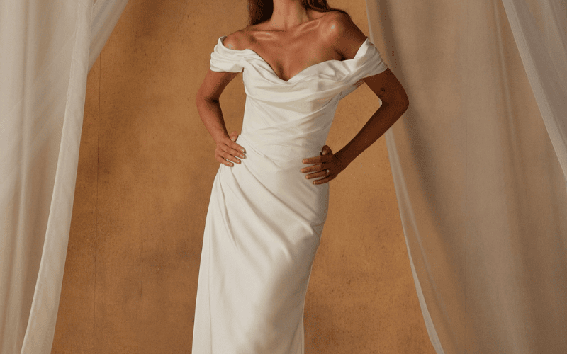 bride wearing an off-shoulder sheath wedding dress
